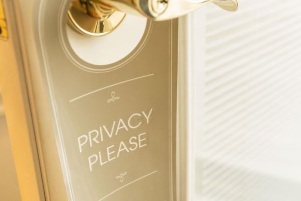 A door handle features a "Privacy Please" sign hanging, indicating a request for privacy.